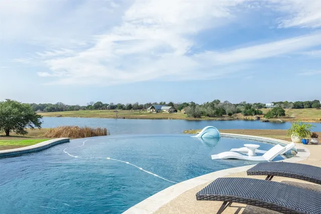 a view of a lake with couches in the patio
