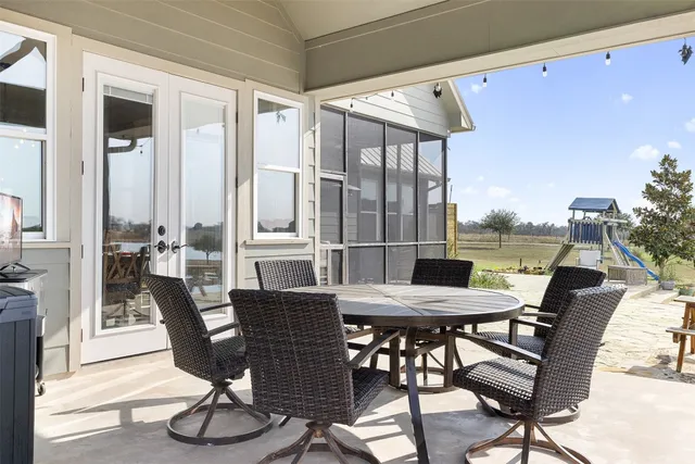a view of a patio with a table and chairs