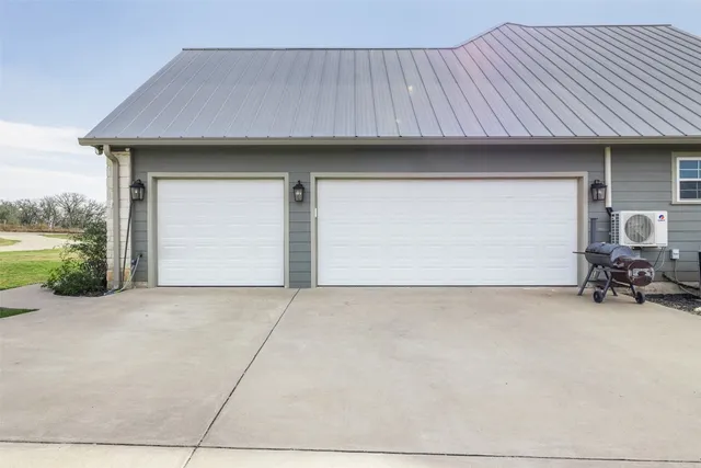 a view of backyard of house and car parked