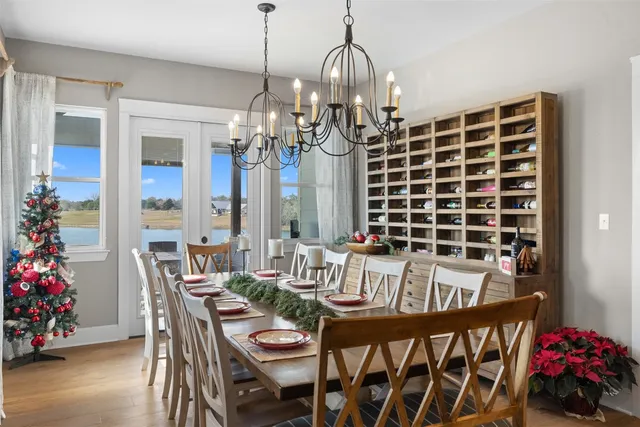 a view of a dining room with furniture and chandelier