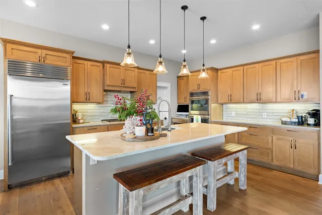 a kitchen with kitchen island a stove a sink and a refrigerator
