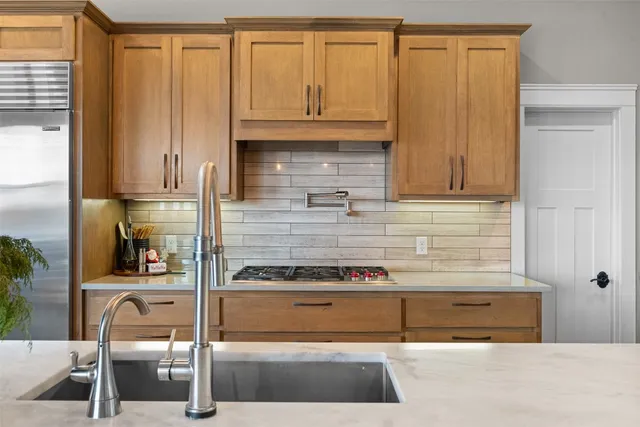 a kitchen with a refrigerator and cabinets