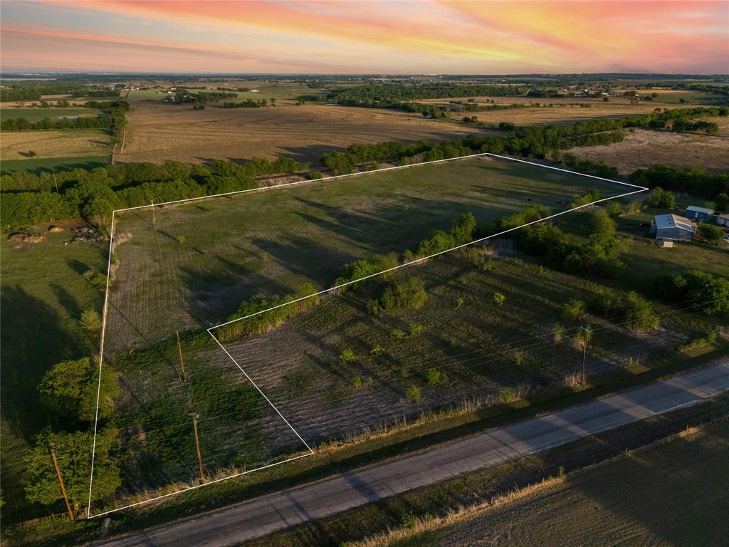 Tbd Willow Grove Road Moody, TX 76557 - Photo 8 of 23 Expansive land offering a mix of grassy areas and mature trees, bordered by a road, and featuring distant buildings