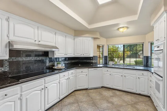 a spacious bedroom with a bed and a chandelier