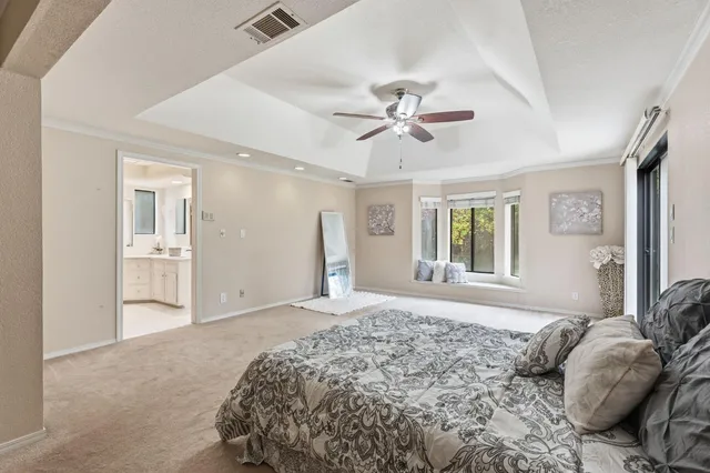 a bathroom with a granite countertop double vanity sink a mirror and a bathtub