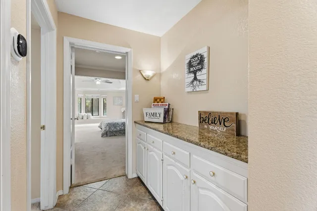 a kitchen with granite countertop a sink and a stove