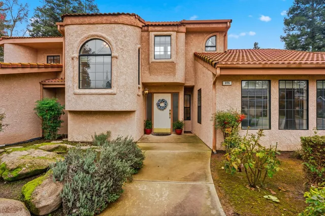 a living room with furniture large window and a table