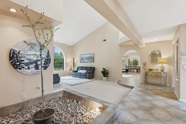 a spacious bedroom with a bed a couch and a large window