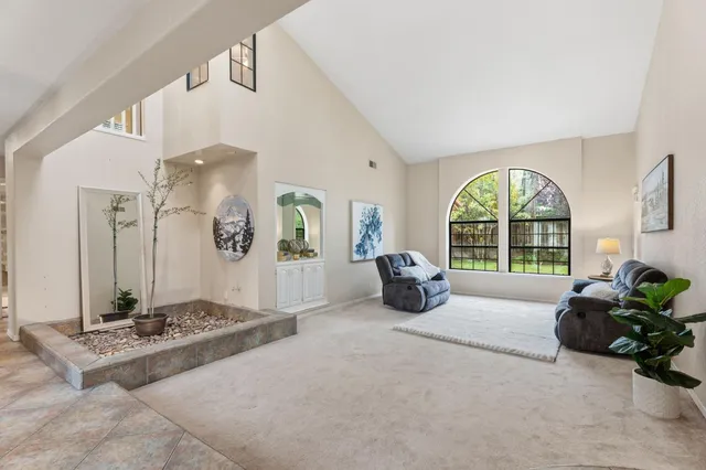 a dining room with furniture a chandelier and wooden floor