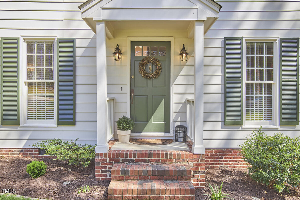 7424 Old Fox Trail Raleigh, NC 27613 - Photo 3 of 34 a front view of a house with a yard