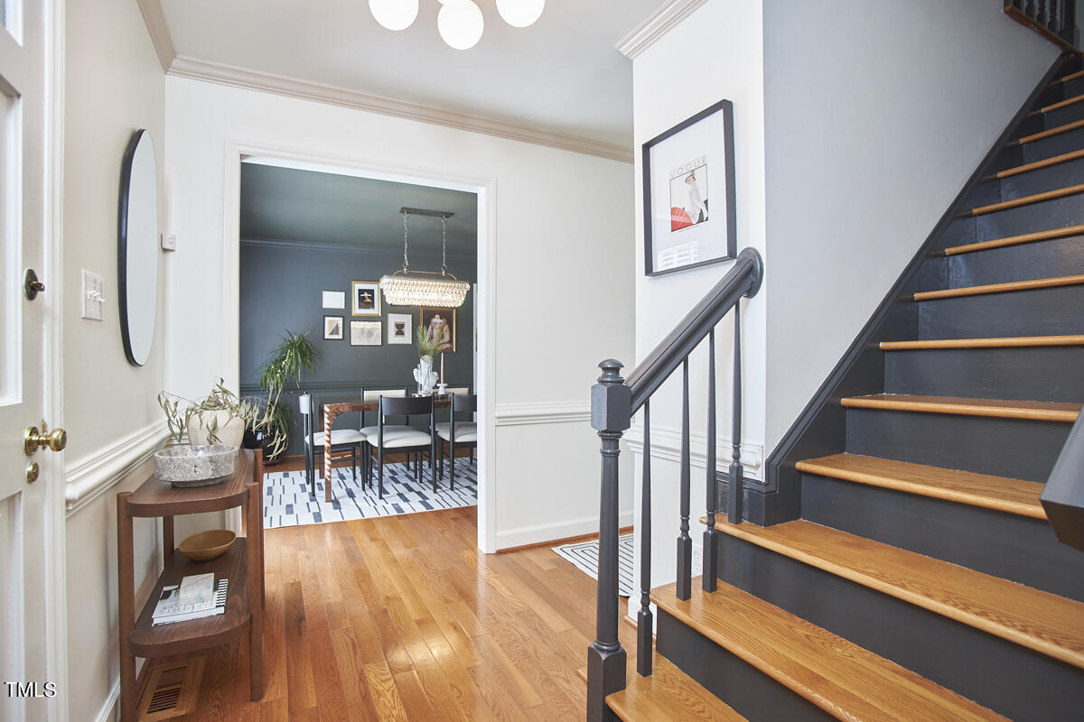 7424 Old Fox Trail Raleigh, NC 27613 - Photo 5 of 34 a view of staircase with dining room and wooden floor
