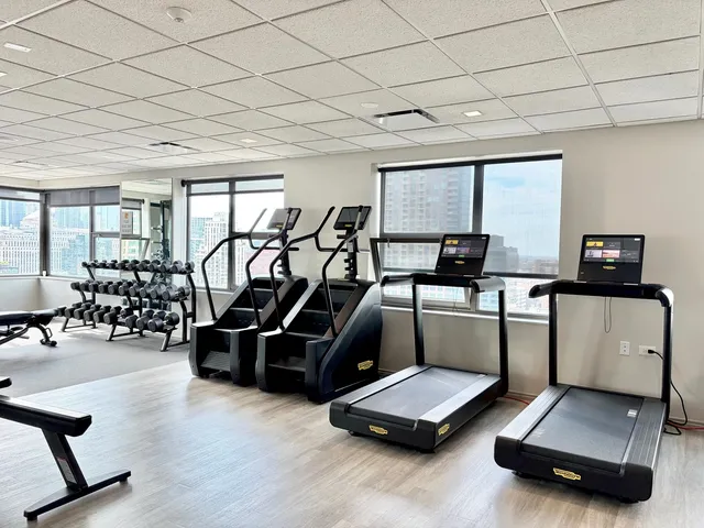 a room with gym equipment and a large window
