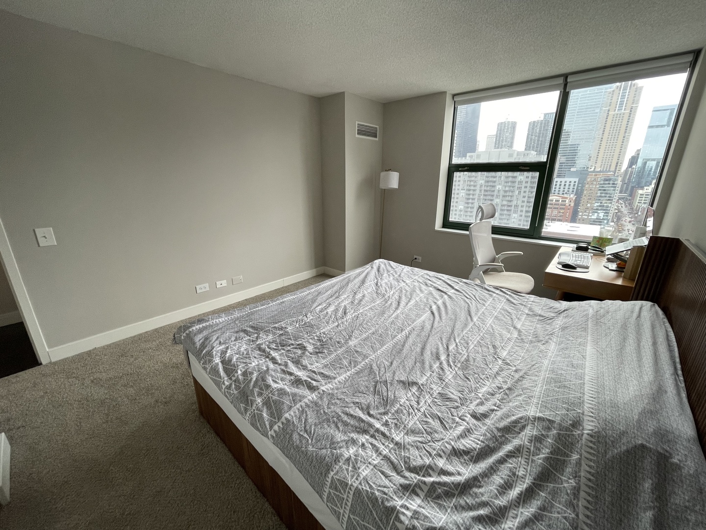 77 West Huron Street, Unit 1803 Chicago, IL 60654 - Photo 7 of 22 a bedroom with a bed and a large window
