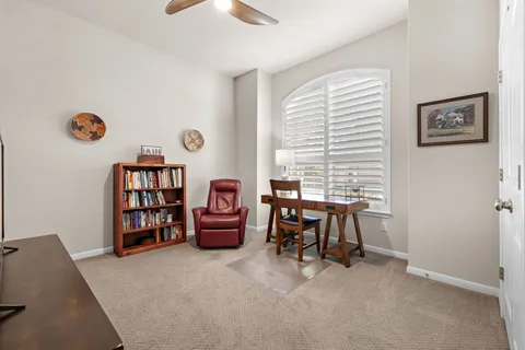 a bedroom with furniture and a book shelf