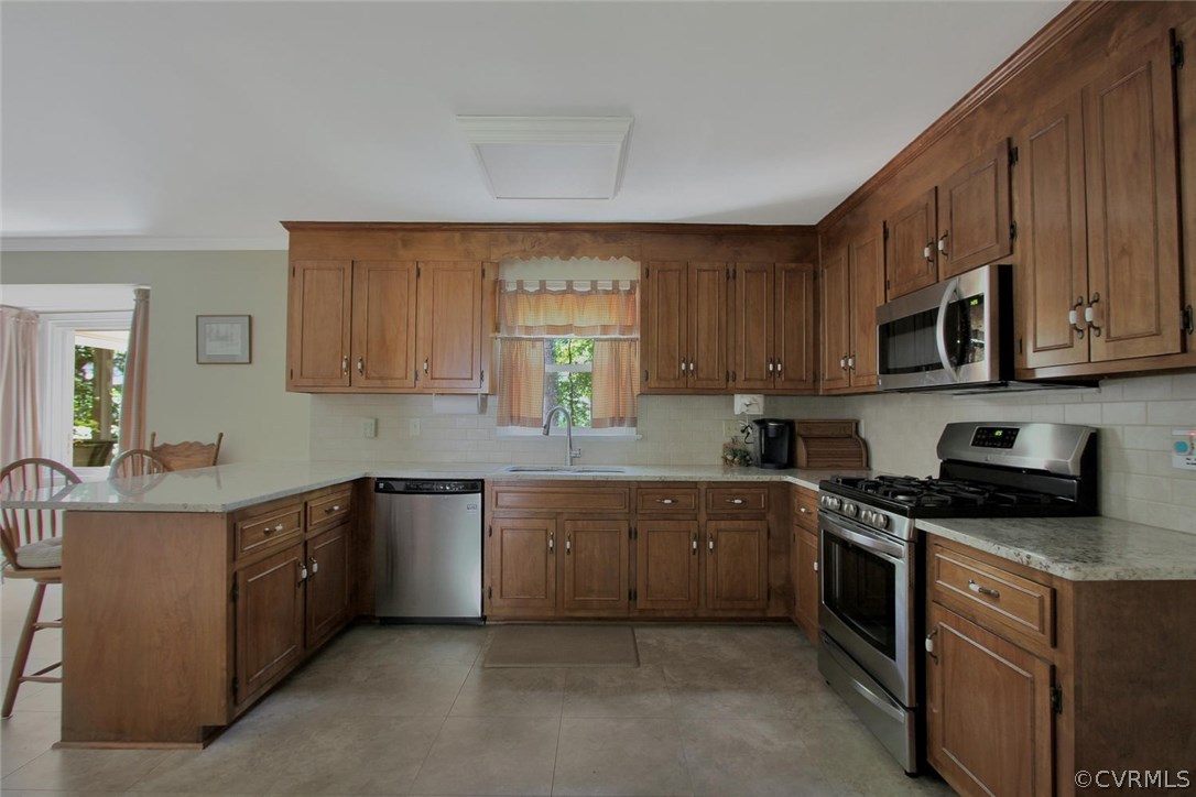 13808 Shadow Ridge Road Midlothian, VA 23112 - Photo 8 of 29 a kitchen with stainless steel appliances granite countertop wooden cabinets a stove a sink and a window