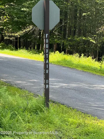 a view of a backyard with table and chairs under an umbrella