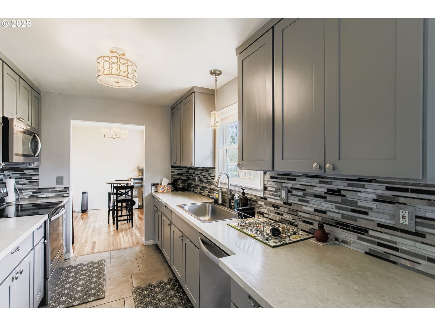 830 Southeast 214th Avenue Gresham, OR 97030 - Photo 14 of 30 a kitchen with stainless steel appliances a stove a sink and a refrigerator