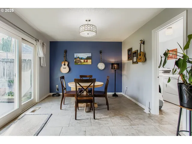 a dining room with furniture and window