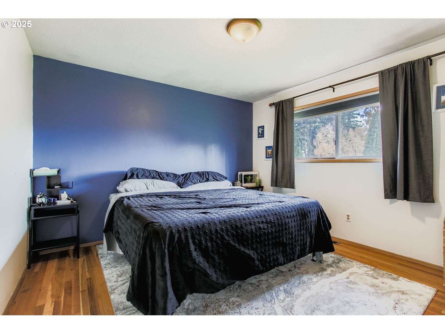830 Southeast 214th Avenue Gresham, OR 97030 - Photo 17 of 30 a bedroom with a bed and wooden floor
