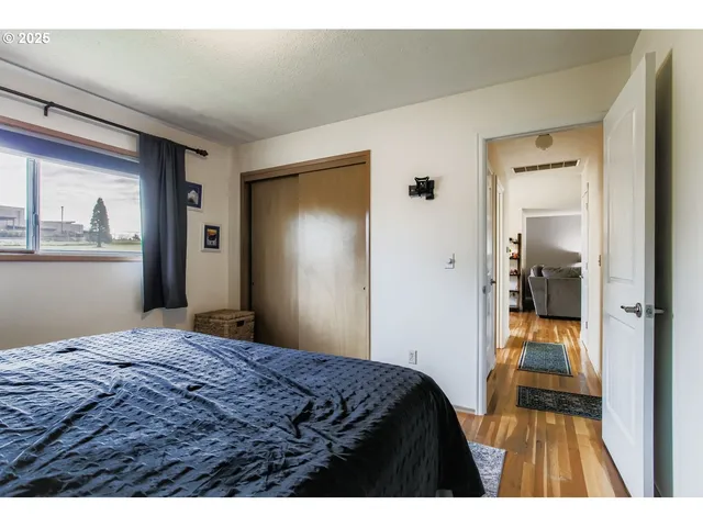 a bedroom with a bed and a painting on the wall