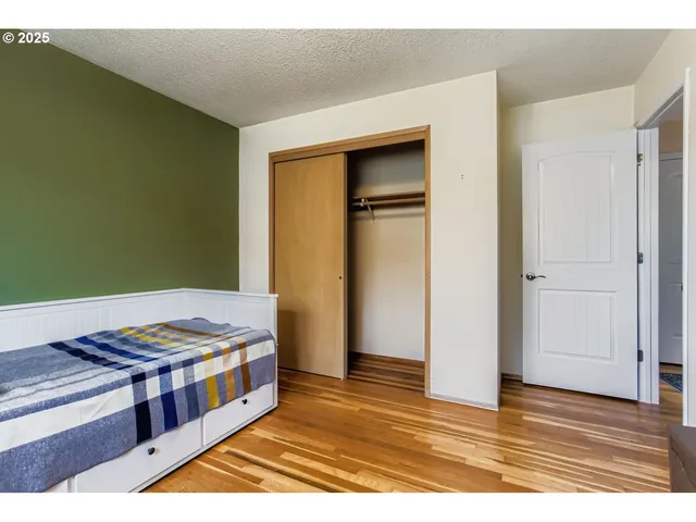 a view of kitchen with stainless steel appliances granite countertop a stove and a wooden floor