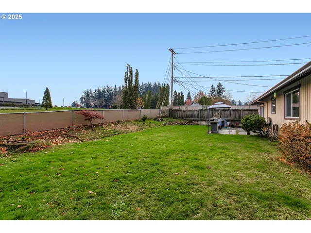 a view of a house with a yard and sitting area