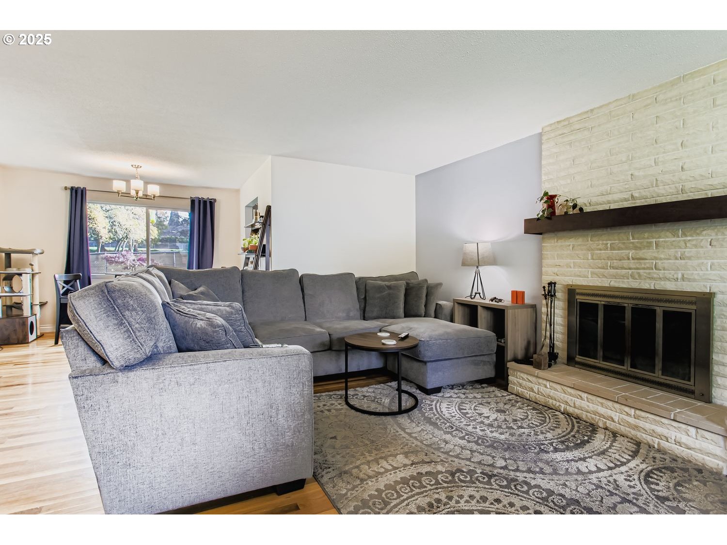 830 Southeast 214th Avenue Gresham, OR 97030 - Photo 6 of 30 a living room with furniture and a fireplace