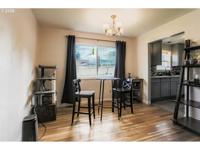a view of a dining room with furniture and a chandelier