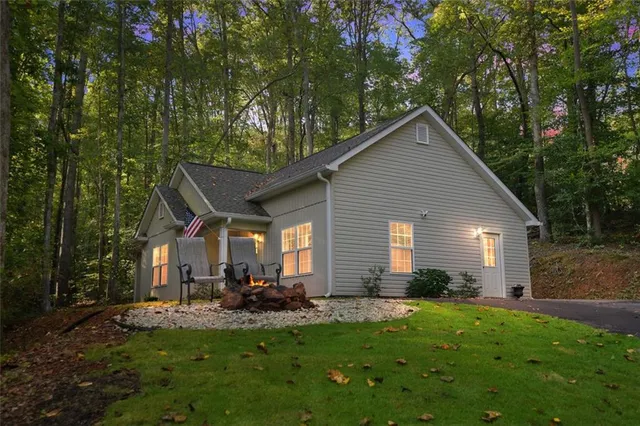 a view of a house with backyard and sitting area