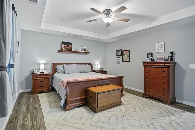 a spacious bedroom with a bed and a chandelier
