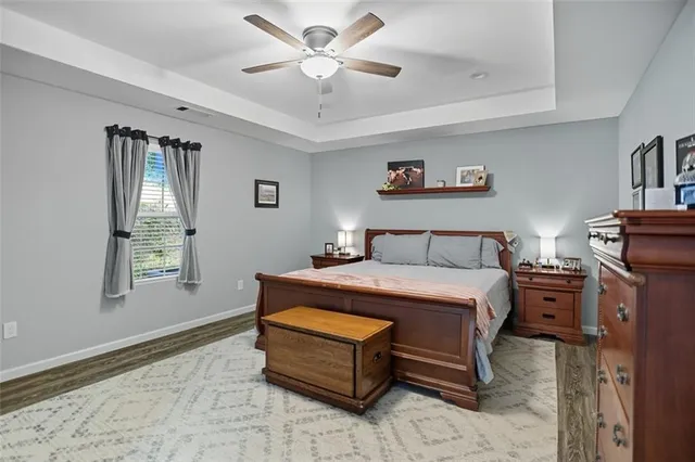 a spacious bedroom with a bed and a chandelier