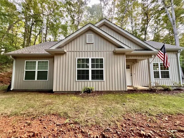 a front view of a house with a garden