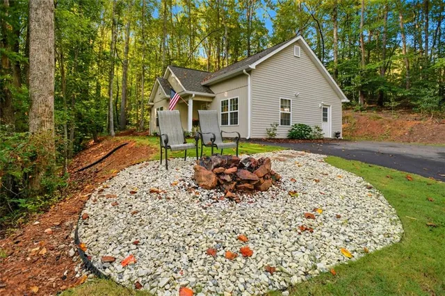 a view of a house with backyard sitting area and garden