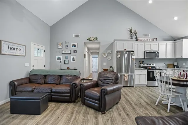 a living room with furniture and kitchen view