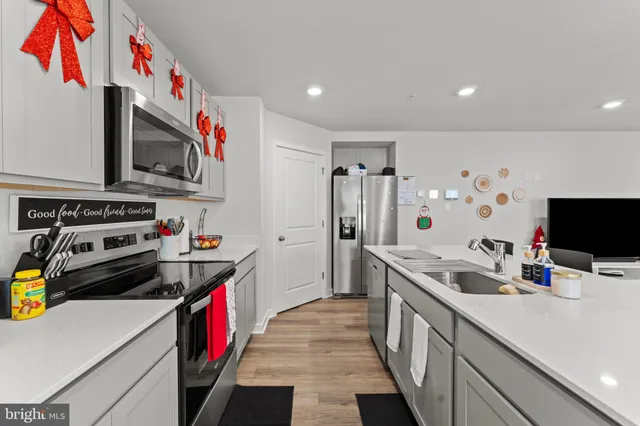 a kitchen with stove cabinets and living room