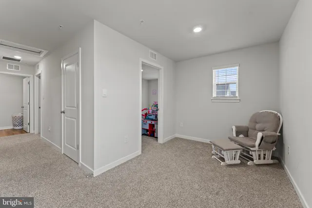 a view of a room with gym equipment and windows
