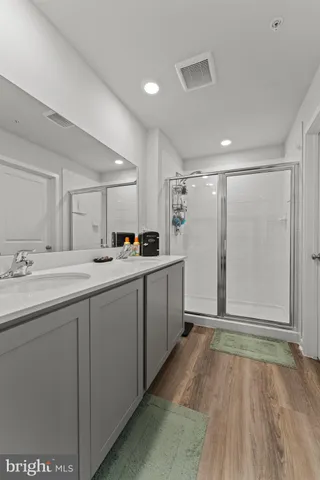 a en suite bathroom with a double sink and a mirror
