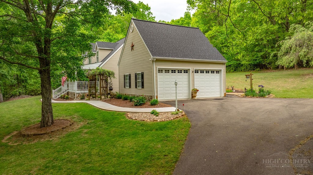 970 Vox Road Sparta, NC 28675 - Photo 5 of 50 a view of a house with backyard and garden