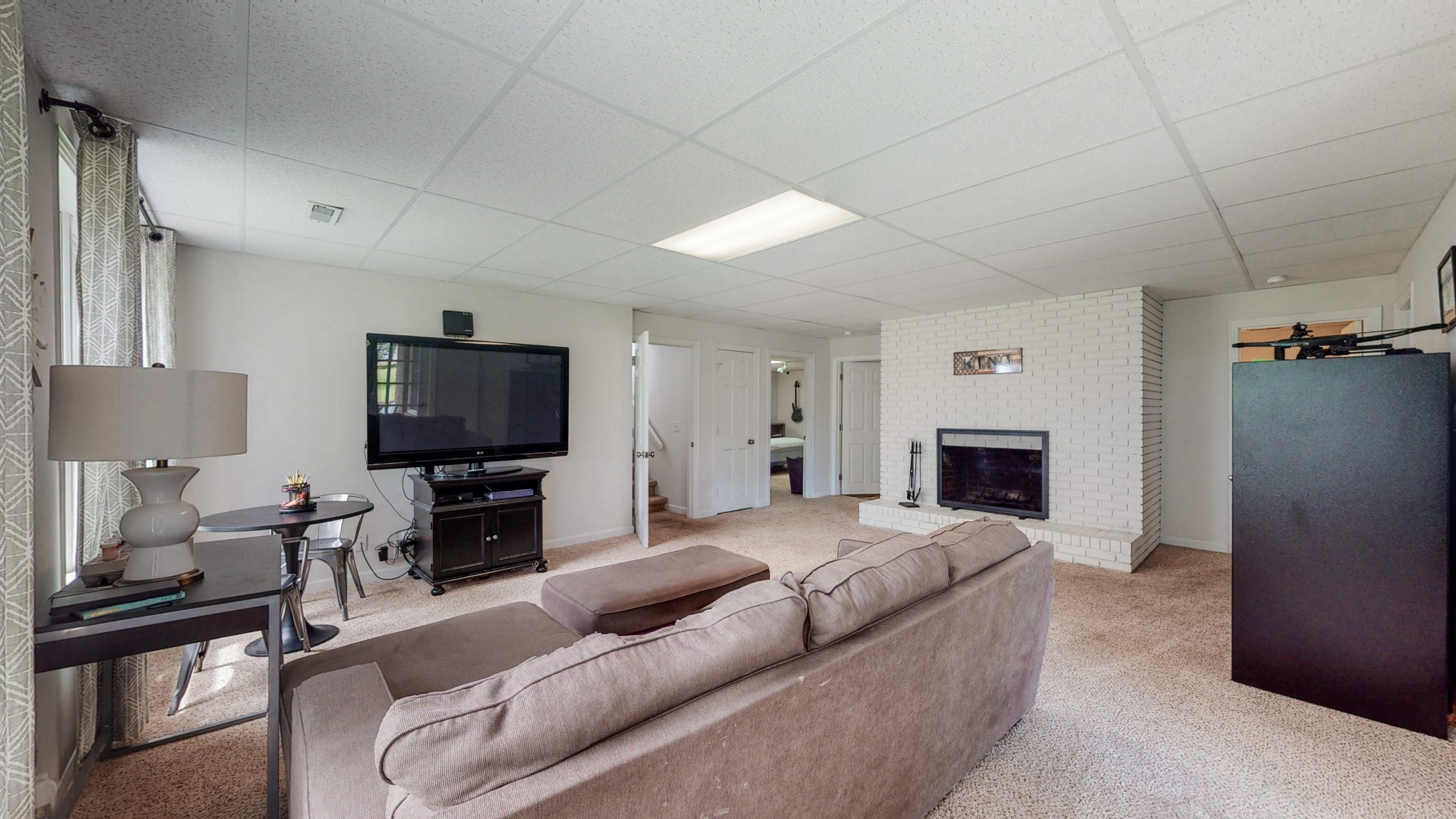 211 Old Horn Springs Road Lebanon, TN 37087 - Photo 22 of 43 a living room with furniture a fireplace and a flat screen tv