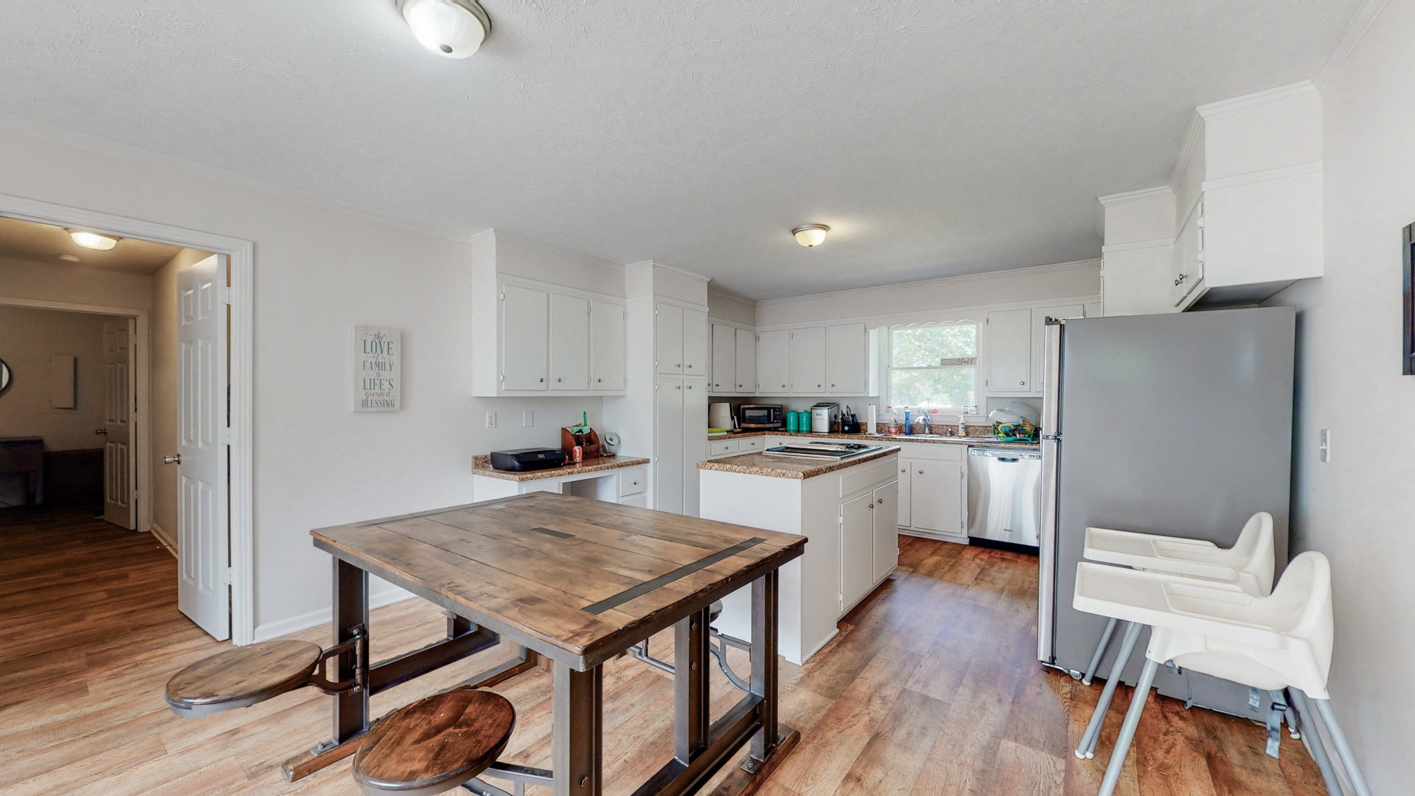211 Old Horn Springs Road Lebanon, TN 37087 - Photo 8 of 43 a kitchen with a table chairs refrigerator and wooden cabinets