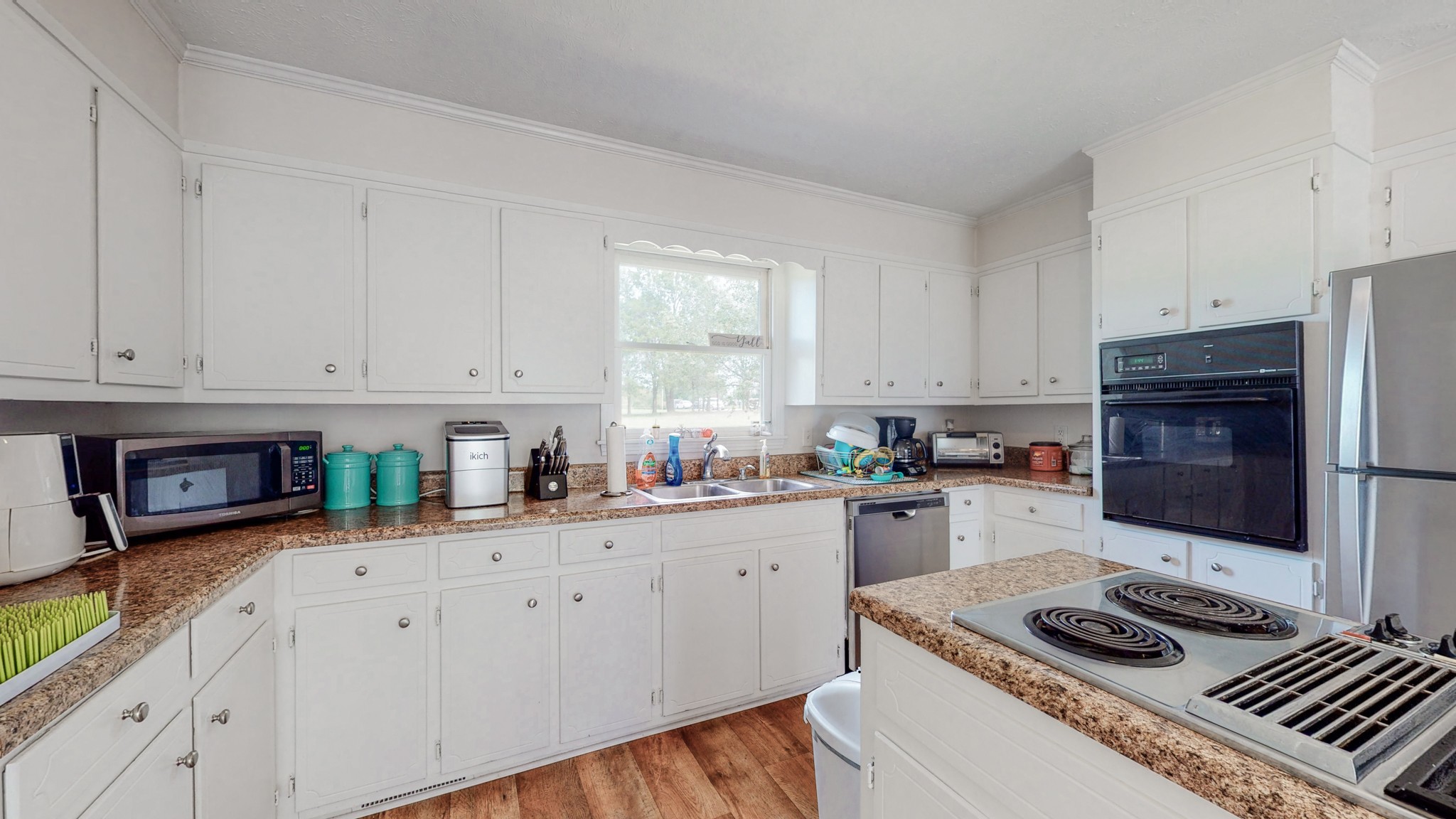 211 Old Horn Springs Road Lebanon, TN 37087 - Photo 10 of 43 a kitchen with granite countertop a sink stove and cabinets