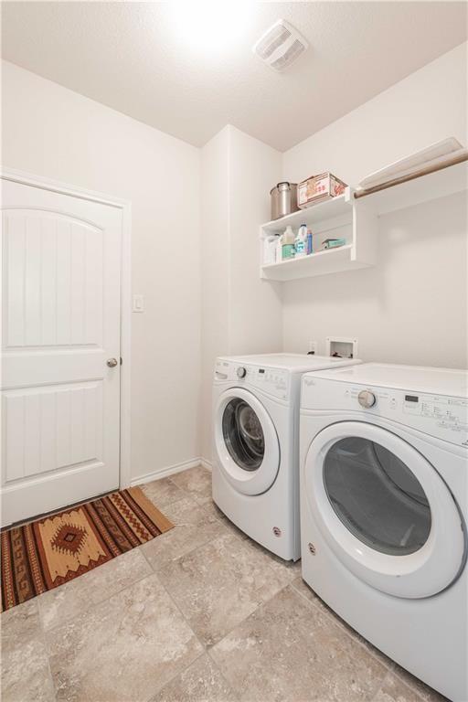 1716 Rio Penasco Road Fort Worth, TX 76052 - Photo 23 of 31 Laundry area featuring tile flooring, built-in shelving, and a clothing rod