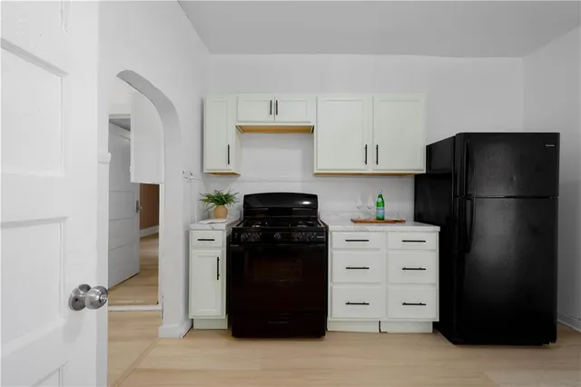 a view of a utility room with closet and wooden floor