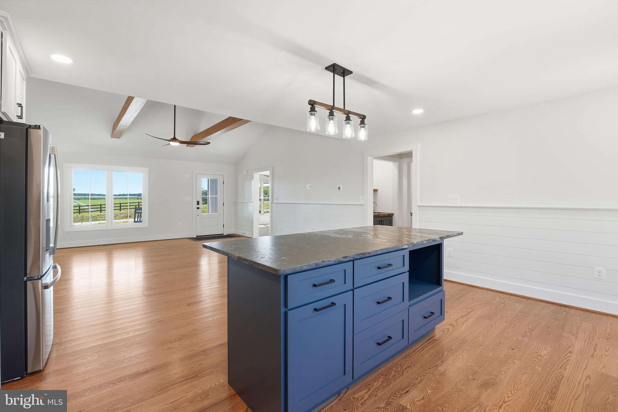 1548 James City Road Reva, VA 22735 - Photo 15 of 48 a kitchen with granite countertop a stove and a wooden floors