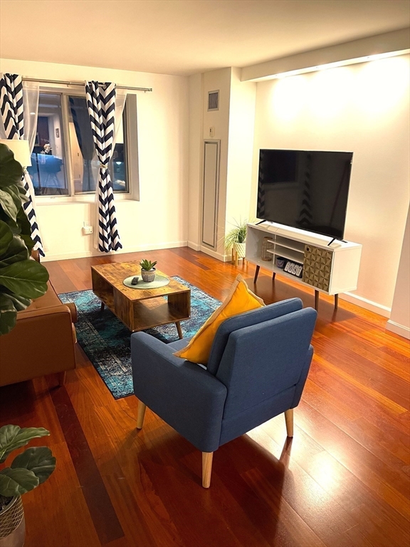 10 Museum Way, Unit 321 Cambridge, MA 02141 - Photo 2 of 15 a living room with furniture and a flat screen tv