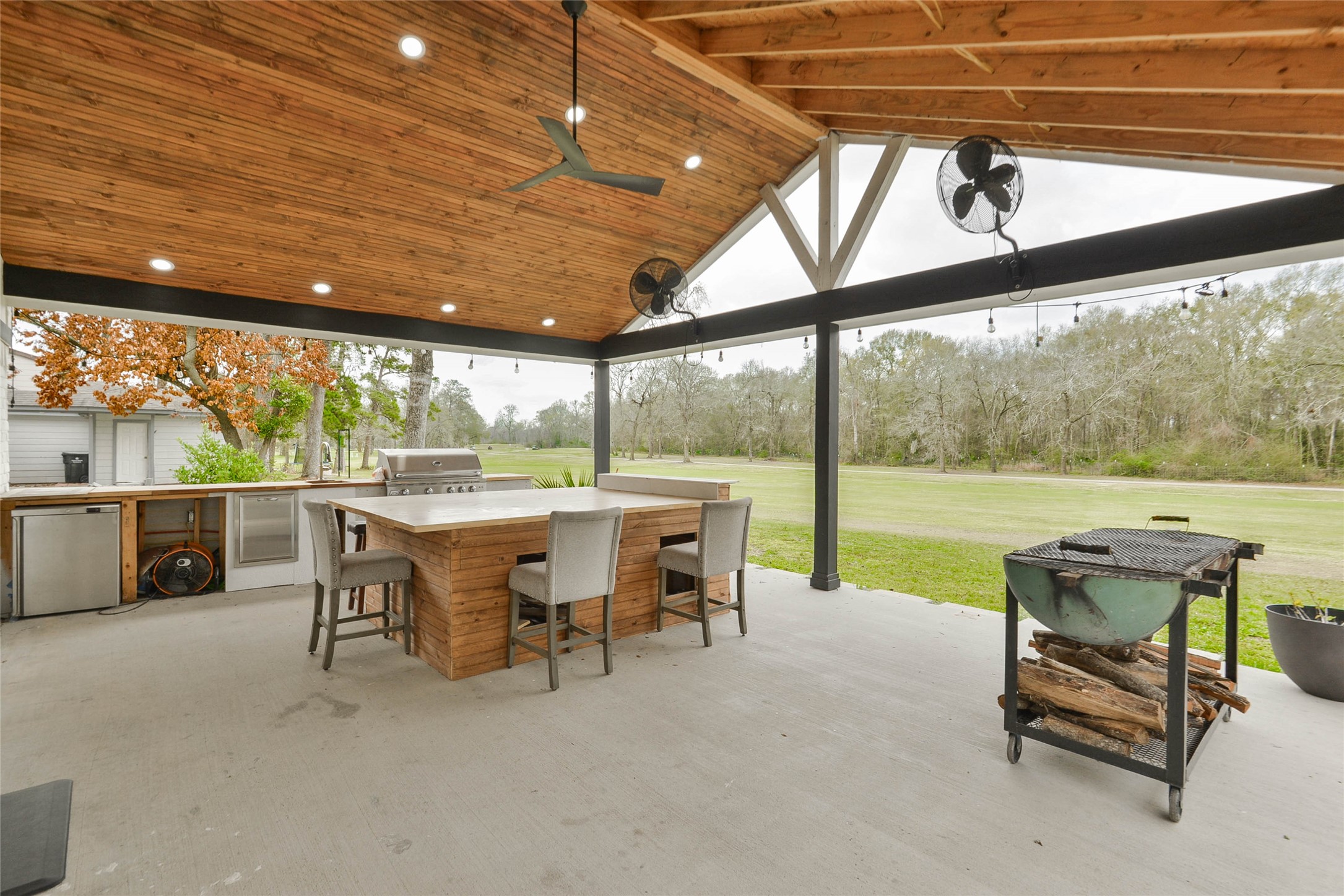 531 Brandon Road Conroe, TX 77302 - Photo 6 of 33 a view of a patio with table and chairs next to a yard