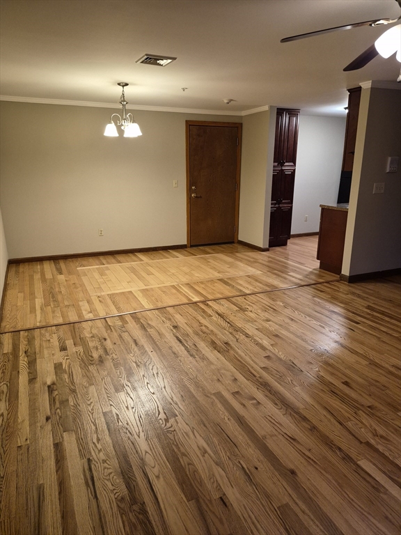 333 1st Street, Unit 209 Lowell, MA 01850 - Photo 13 of 16 a view of an empty room with wooden floor