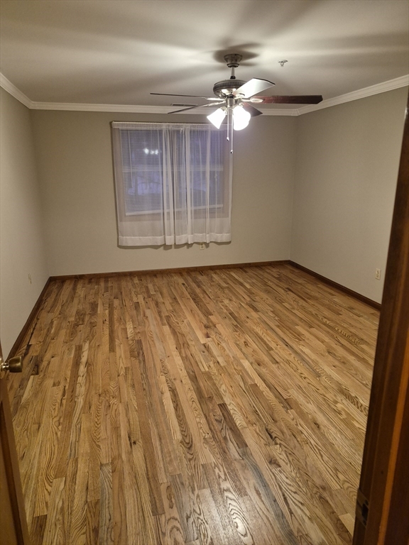333 1st Street, Unit 209 Lowell, MA 01850 - Photo 8 of 16 a view of an empty room with wooden floor and chandelier