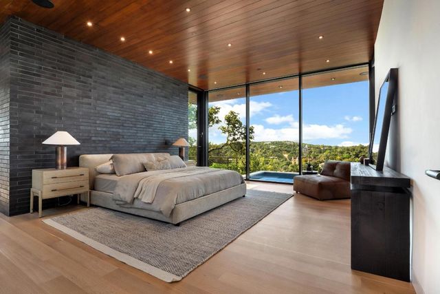 a bedroom with a bed and large window