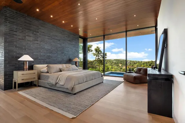 a bedroom with a bed and large window